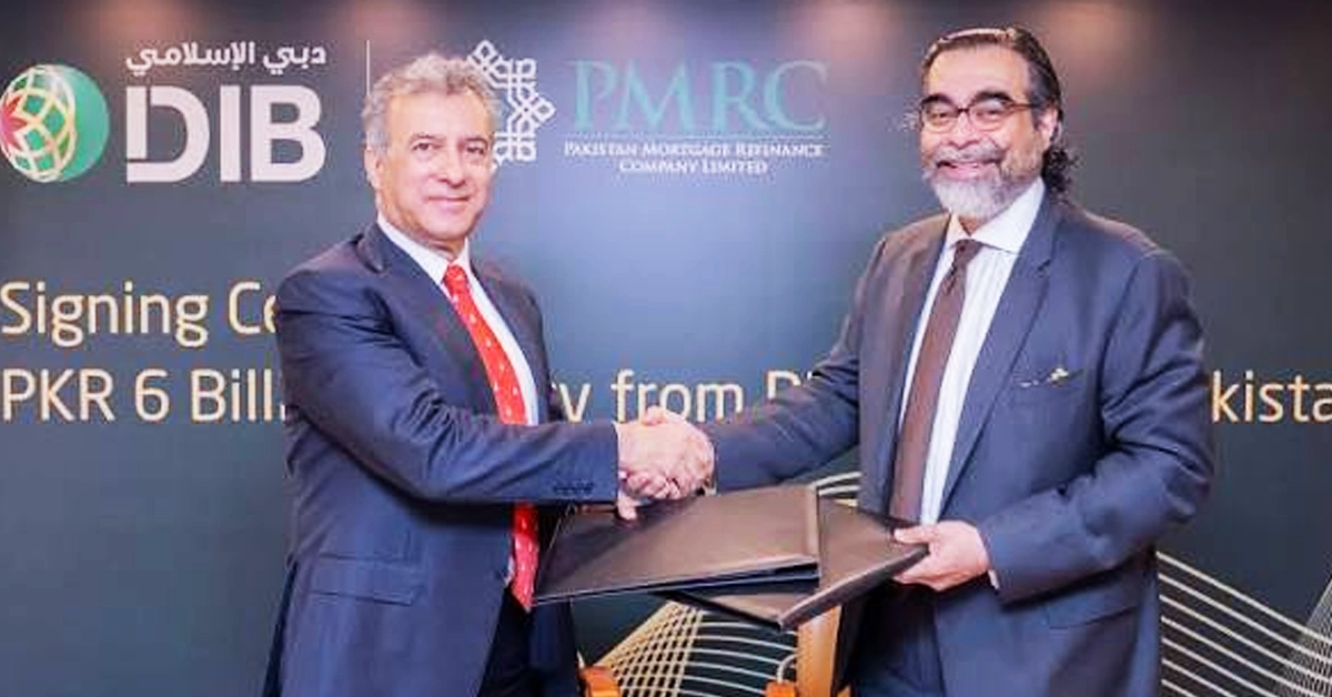 Dubai Islamic Bank Pakistan and PMRC officials exchanging agreement documents for Islamic housing finance deal