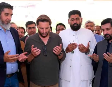 Former cricketer Shahid Afridi receiving a shield at the inauguration of the National Institute of Leather Technology in Karachi.