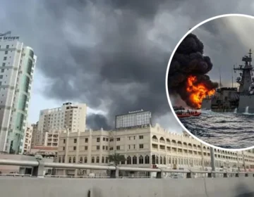 Explosions lit up the night sky over a middle eastern coastal city during a military airstrike.