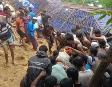 Mud and debris from a landslide covering temporary shelters in a rain-hit refugee camp.