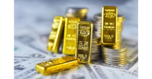 Gold bars and coins on a financial chart background.