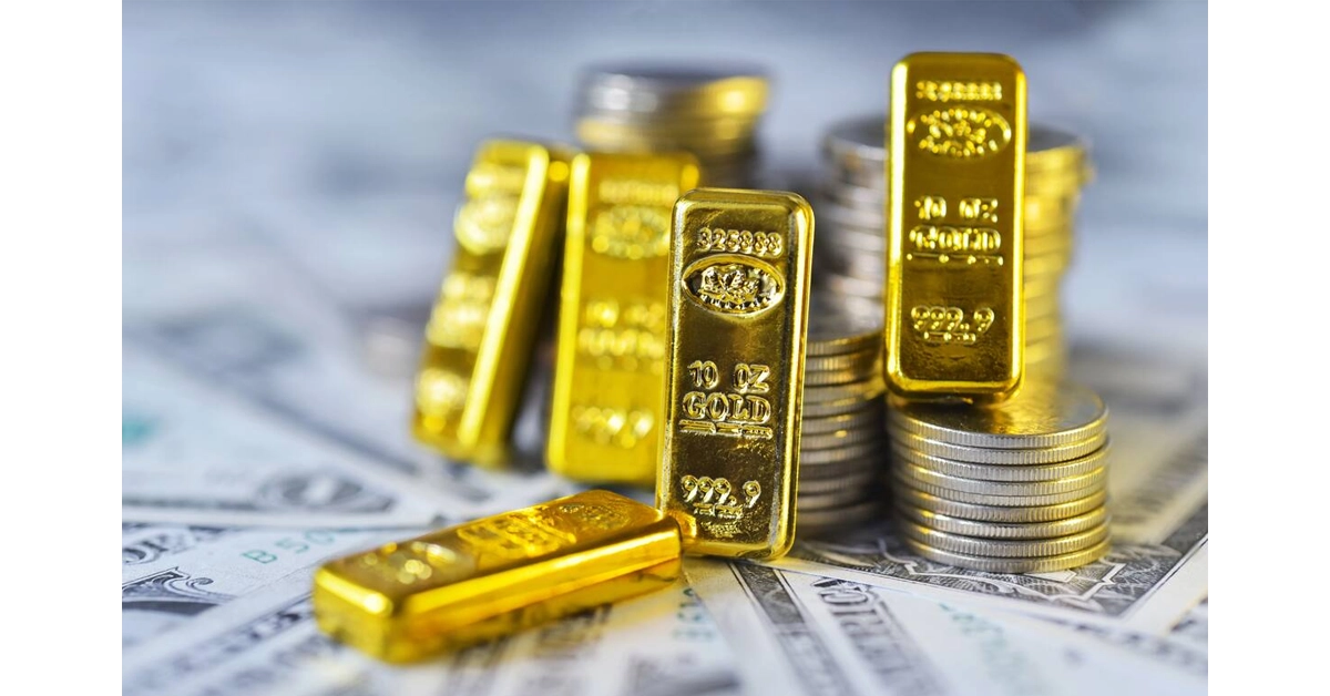 Gold bars and coins on a financial chart background.