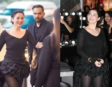 Pakistani actress Hania Amir posing in a bold black western outfit at a luxury brand launch event.