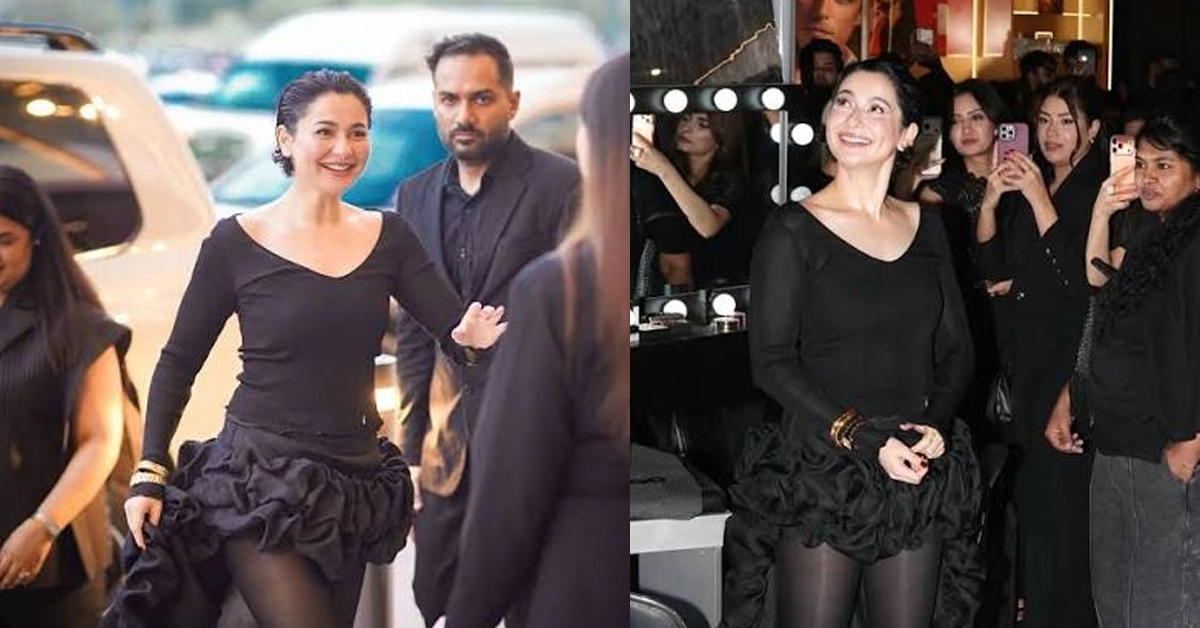 Pakistani actress Hania Amir posing in a bold black western outfit at a luxury brand launch event.