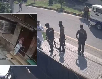 Lahore police officers standing in a street during a crime scene investigation and suspect search operation