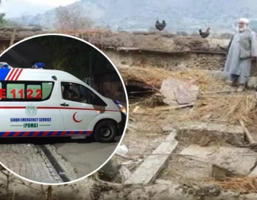 Rescue 1122 workers clearing the debris of a collapsed house in Kohat after heavy rains