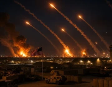 Air defense systems firing interceptor missiles into the sky over Kuwait during a military conflict.