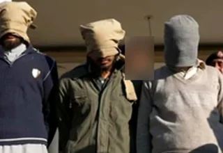 Counter Terrorism Department (CTD) police officials presenting seized explosive materials and weapons at a press conference in Karachi.