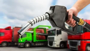 A fuel pump nozzle being operated at a gas station for refueling during fuel price changes in Pakistan