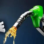 Fuel nozzle pouring petrol at a gas station in Pakistan.