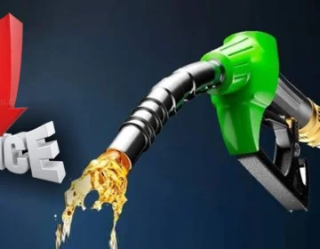 Fuel nozzle pouring petrol at a gas station in Pakistan.