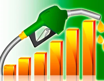 A fuel nozzle dispensing petrol at a local gas station in Pakistan with updated pricing.