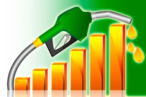 A fuel nozzle dispensing petrol at a local gas station in Pakistan with updated pricing.