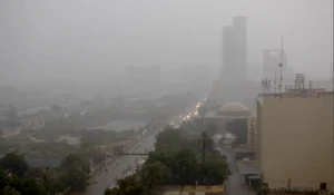 Dark clouds and heavy rain pouring down on Karachi roads and city view
