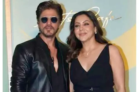Bollywood actor Shah Rukh Khan and his wife Gauri Khan posing outside a luxury residential property.