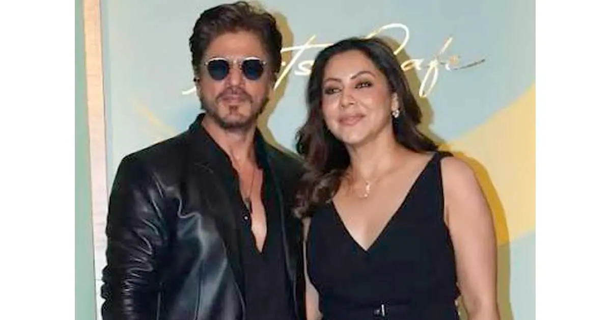 Bollywood actor Shah Rukh Khan and his wife Gauri Khan posing outside a luxury residential property.