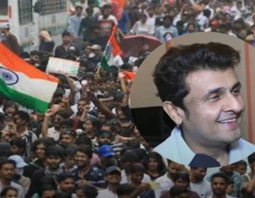 Playback singer Sonu Nigam singing live holding a microphone on stage during concert performance