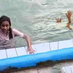 Lahore police team investigating the open drain hole in a public swimming pool area