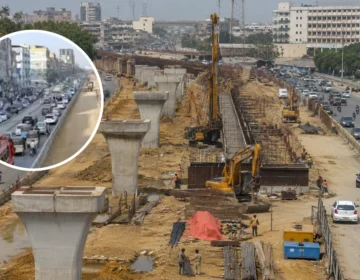 Under-construction track of Red Line BRT on University Road Karachi showing dust and road barriers for traffic diversion