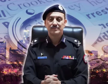 Additional IG Karachi Azad Khan speaking at a podium during a meeting with business leadership