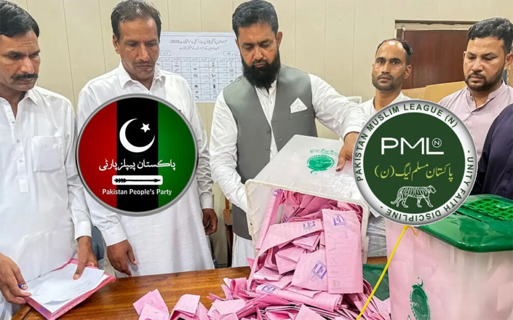 Voters casting ballots at a polling station booth during Azad Jammu Kashmir assembly elections