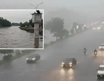 A sleek visual graphic depicting heavy rain clouds with water waves and a red danger siren representing monsoon urban flood alert without text