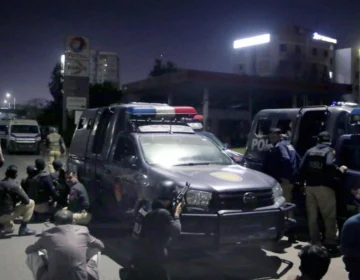 Sindh Police team and forensic vehicle inspecting crime scene after encounter in Karachi