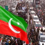 Pakistan Tehreek-e-Insaf workers waving party flags during a protest rally heading towards Islamabad