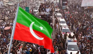 Pakistan Tehreek-e-Insaf workers waving party flags during a protest rally heading towards Islamabad